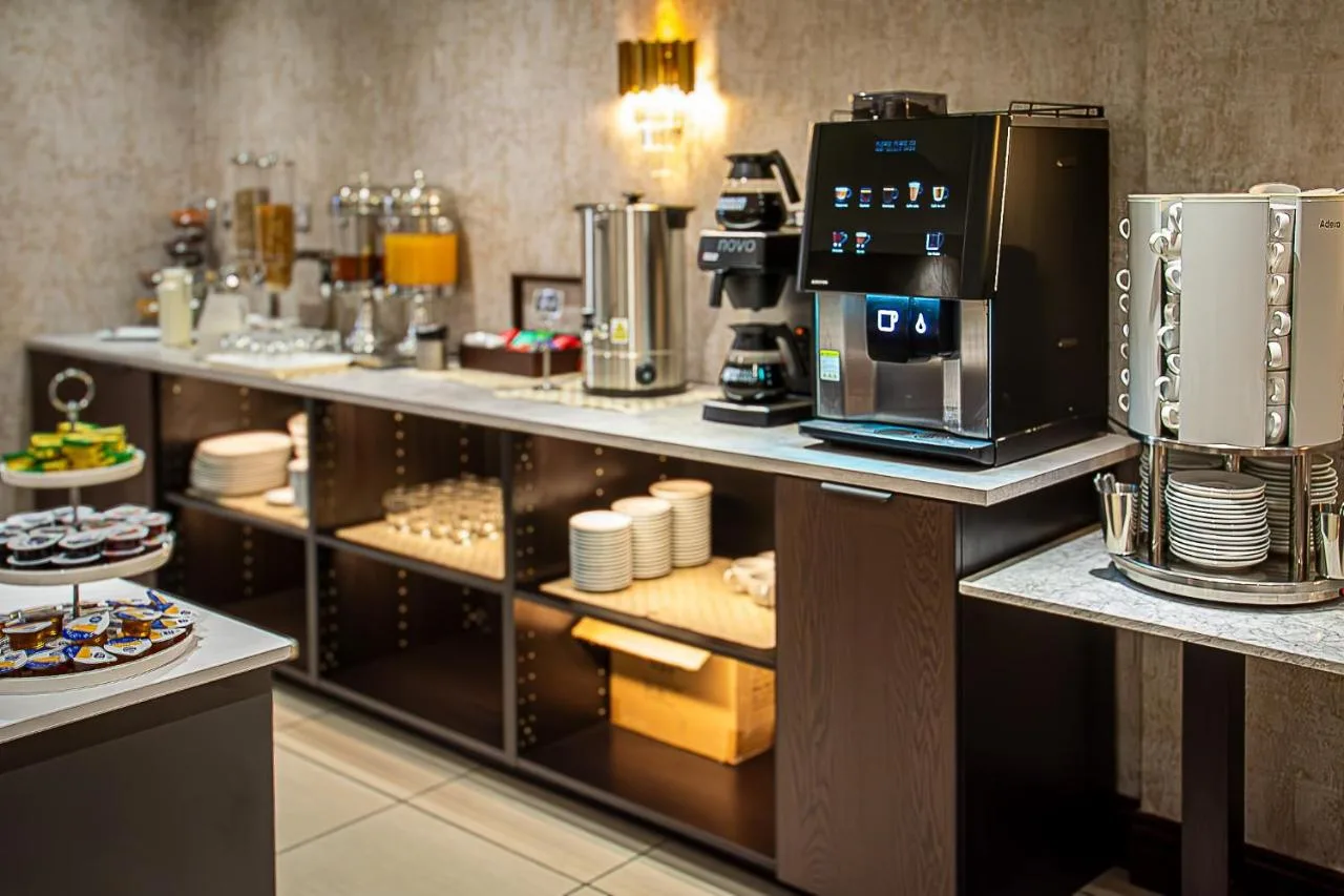 a coffee shop with a coffee machine on display at Hyde Park International, Inverness Terrace, London