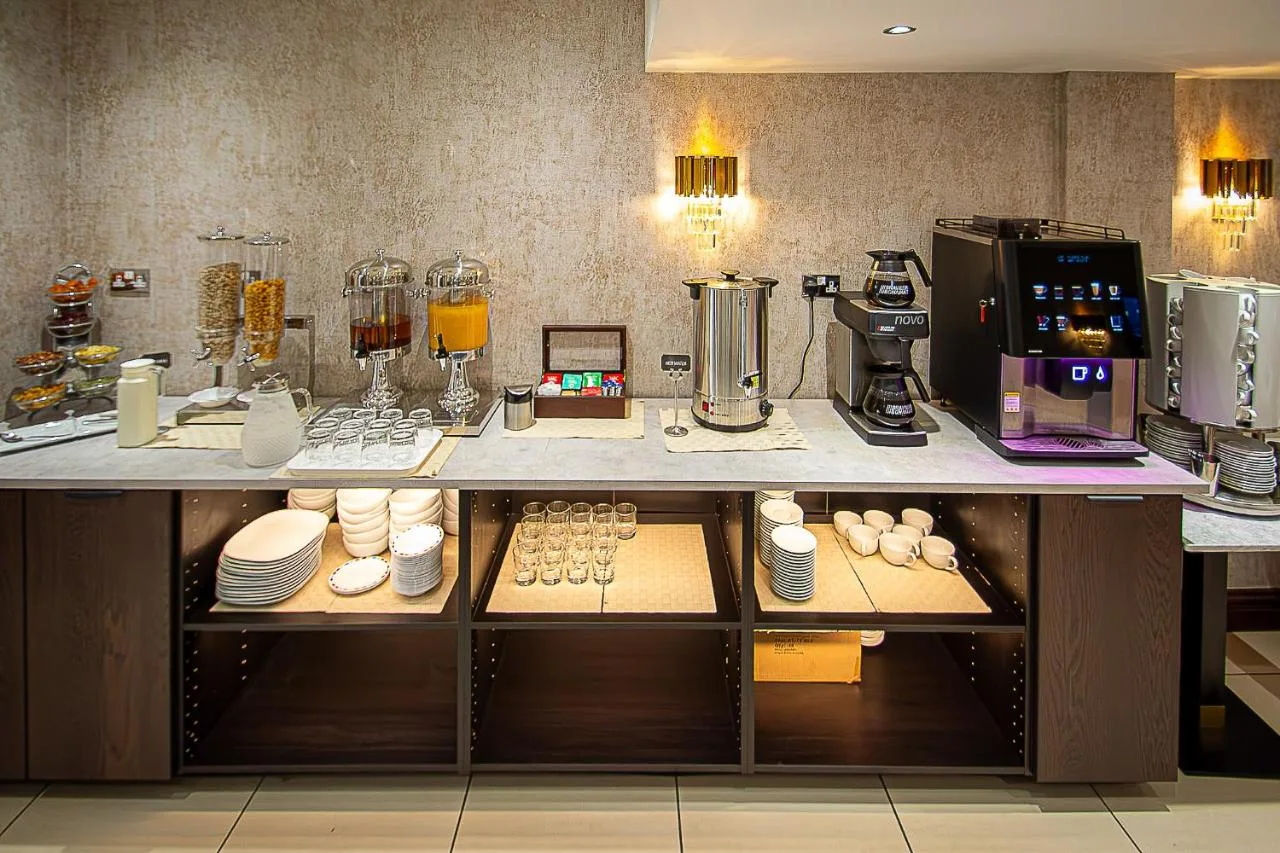 a kitchen with a counter with a coffee machine at Hyde Park International in Bayswater